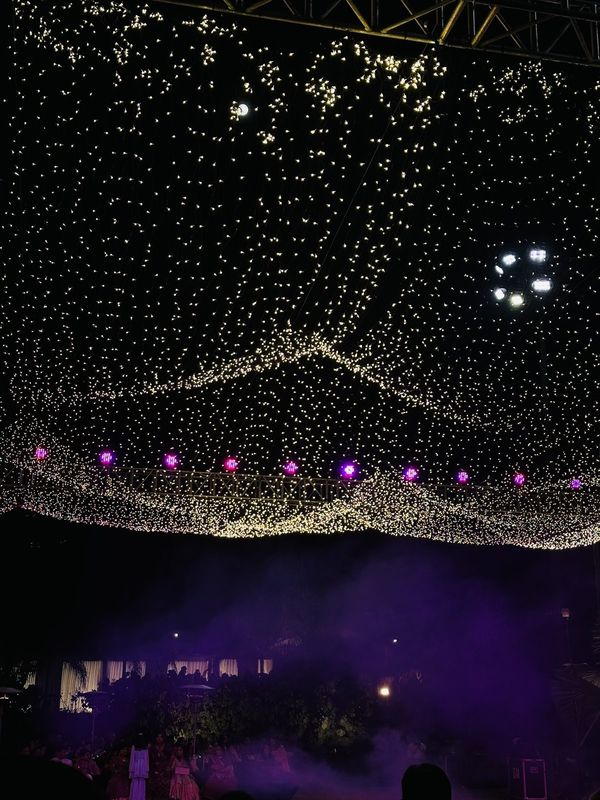 A canopy of fairy lights at a night celebration